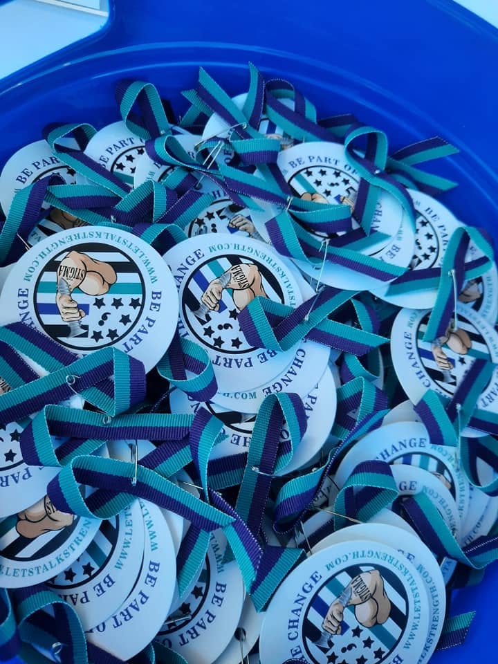 Suicide prevention awareness ribbons handed out at an outreach event